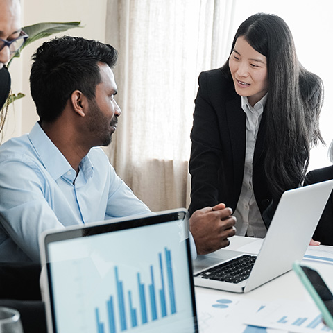 business professionals collaborating in an office discussing data and statistics with graphs and charts related to performance and project outcomes including nine key insights