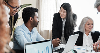 business professionals collaborating in an office discussing data and statistics with graphs and charts related to performance and project outcomes including nine key insights
